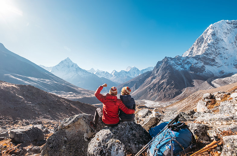 Couple Overlooking A Mountain Range